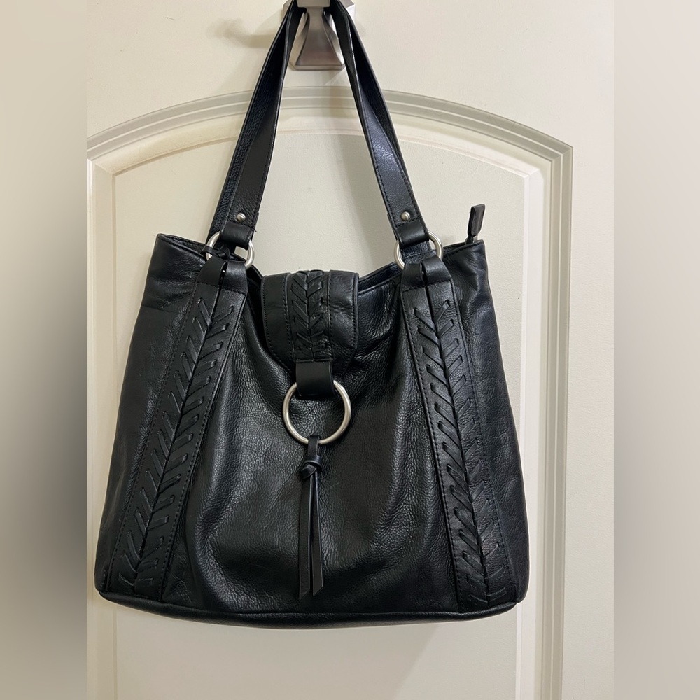 Black leather bag never been used. Faux leather trim.
